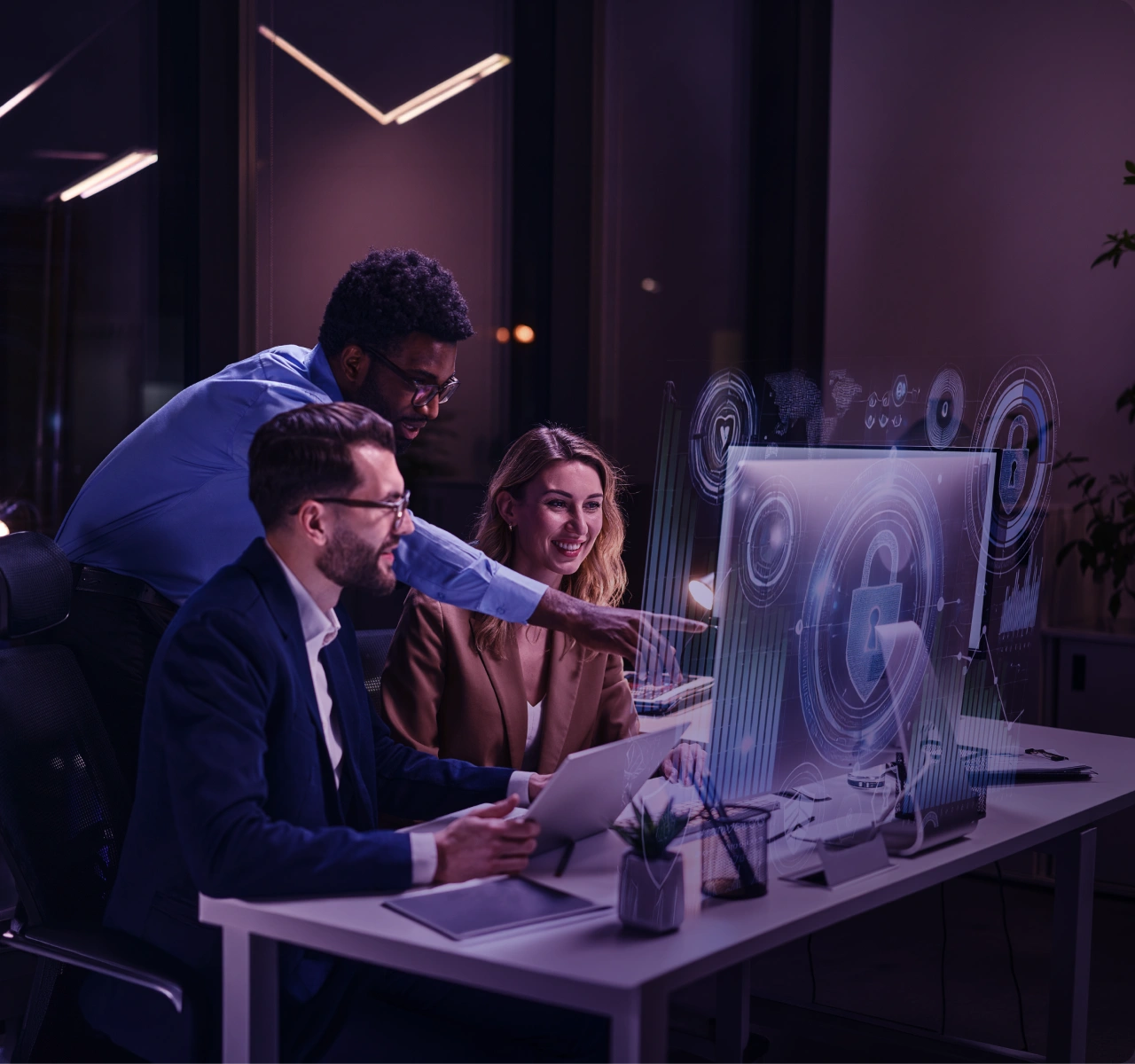 Team collaborating around computers in a technology workspace